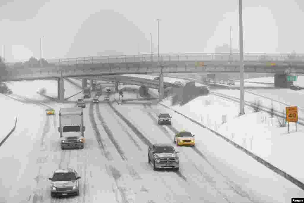Motorists drive along a snow covered Interstate-94 in Detroit, Michigan Jan. 2, 2014. 