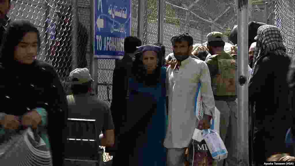 Families carried their belongings in plastic bags as they left for Afghanistan. 