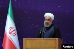 In this photo released by the office of the Iranian Presidency, President Hassan Rouhani speaks in a ceremony to mark "National Nuclear Day," dedicated to the country's achievements in nuclear technology, April 9, 2018.