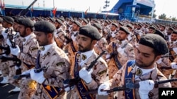 FILE - Members of Iran's Revolutionary Guards Corps (IRGC) march during the annual military parade marking the anniversary of the outbreak of the devastating 1980-1988 war with Saddam Hussein's Iraq, in the capital Tehran, Sept. 22, 2018. 