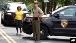 Maryland state police block the road that connects the industrial business park, where several people had been shot, in Harford County, Md, Sept. 20, 2018.