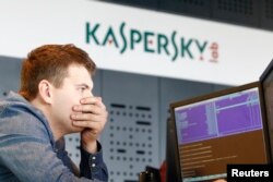 FILE - An employee works near screens in the virus lab at the headquarters of Russian cybersecurity company Kaspersky Labs in Moscow, July 29, 2013.