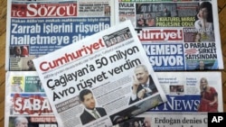 FILE - Front pages of some of Turkish newspapers with headlines concerning a trial in New York against Turkish banker Reza Zarrab, charged with violating U.S. sanctions against Iran, in Ankara, Turkey, Nov. 30, 2017.