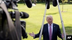 FILE - President Donald Trump speaks to the media as he walks across the South Lawn of the White House in Washington, Sept. 29, 2017.