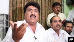 FILE - Jamil Afridi, left, brother of a Pakistani doctor, Shakil Afridi, holds a news conference in Peshawar, Pakistan, May 28, 2012.