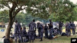 Members of the Uganda People's Defense Force gather in the town of Kasese, Uganda, Monday, Nov. 28, 2016. Rights groups on Monday urged Ugandan security forces to show restraint as they crack down on the members of a tribal militia.