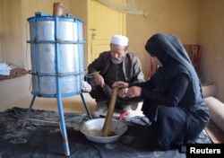 Beekeeper Frozan, 16, checks a beehive in her home in the Marmul district of Balkh province, Afghanistan, March 29, 2018.