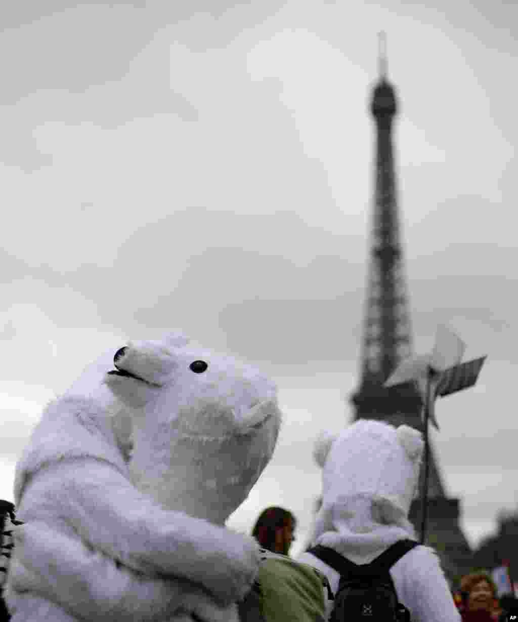 Costumed activists demonstrate near the Eiffel Tower.