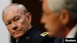 U.S. Secretary of Defense Chuck Hagel (R) and Chairman of the Joint Chiefs of Staff U.S. Army General Martin Dempsey (L) testify before the Senate Armed Services Committee on Capitol Hill in Washington, March 5, 2014.