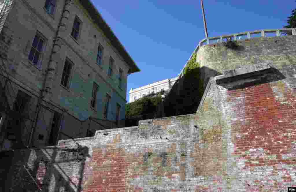 Every turn at&nbsp; Alcatraz reveals layers of its history; the 8-foot-thick wall in the forefront is part of the fort built in the 1800&#39;s, and the prison cell house walls to the left. 