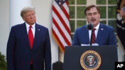 In this March 30, 2020, file photo, My Pillow CEO Mike Lindell speaks as President Donald Trump listens during a briefing about the coronavirus in the Rose Garden of the White House, in Washington. (AP)