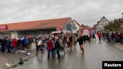 People react at the scene after a car ploughed into a carnival parade injuring several people in Volkmarsen, Germany February 24, 2020. 