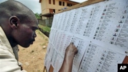A resident checks for his name on a voters' registration list in Lagos, Nigeria, February 18, 2011