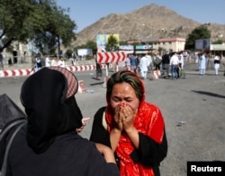 An Afghan woman weeps at the site of a suicide attack in Kabul, Afghanistan July 23, 2016.