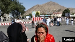 An Afghan woman weeps at the site of a suicide attack in Kabul, Afghanistan July 23, 2016. 