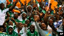 Nigeria fans celebrate in the stands as their team defeated Burkina Faso 1-0 in the final to win the African Cup of Nations soccer tournament, at Soccer City Stadium in Johannesburg, South Africa, Sunday, Feb. 10, 2013. (AP Photo/Rebecca Blackwell)