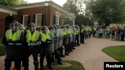 Virginia State Police officers form a cordon at the University of Virginia ahead of the one year anniversary of the 2017 Charlottesville "Unite the Right" protests, in Charlottesville, Va., Aug. 11, 2018.