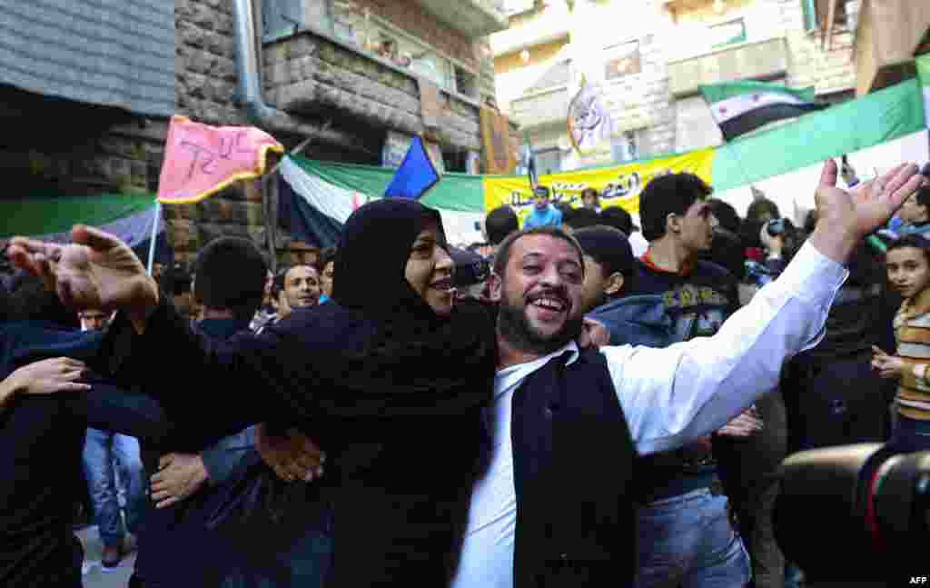 Syrians dance during a demonstration against the regime in the old city of Aleppo in northern Syria on November 16, 2012.