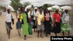 FILE: People take advantage of a maize distribution program in Zimbabwe. (Credit: World Food Program)