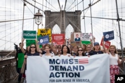 FILE - Hundreds of demonstrators march across the Brooklyn Bridge to call for tougher gun control laws, June 14, 2014, in New York.