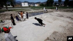 Pakistani boys play at the demolished compound of Osama bin Laden, in Abbottabad, Pakistan, May 2, 2012. 