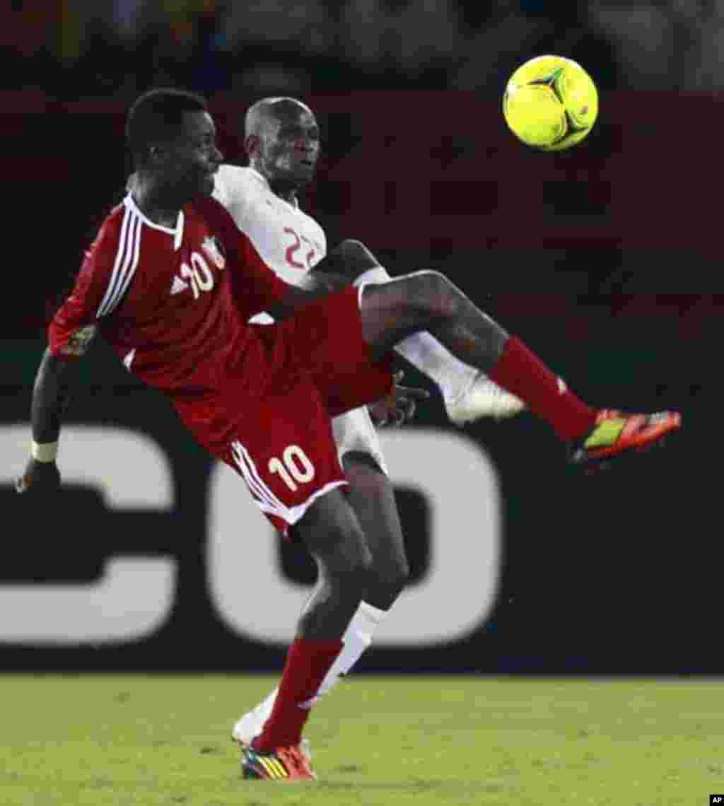 Saidou Panandetiguiri of Burkina Faso (R) fights for the ball with Muhannad Tahir of Sudan during their African Nations Cup Group B soccer match at Estadio de Bata "Bata Stadium", in Bata January 30, 2012.