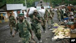 FILE - In this Nov. 30, 2012 file photo, M23 rebels withdraw from the Masisi and Sake areas in the eastern Congo town of Sake, some 27 kms west of Goma, Congo. 