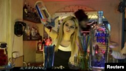 Dana Daqqaq, a bartender at Pub Sharqi, pours a drink during her shift in Damascus, Syria, March 25, 2016.