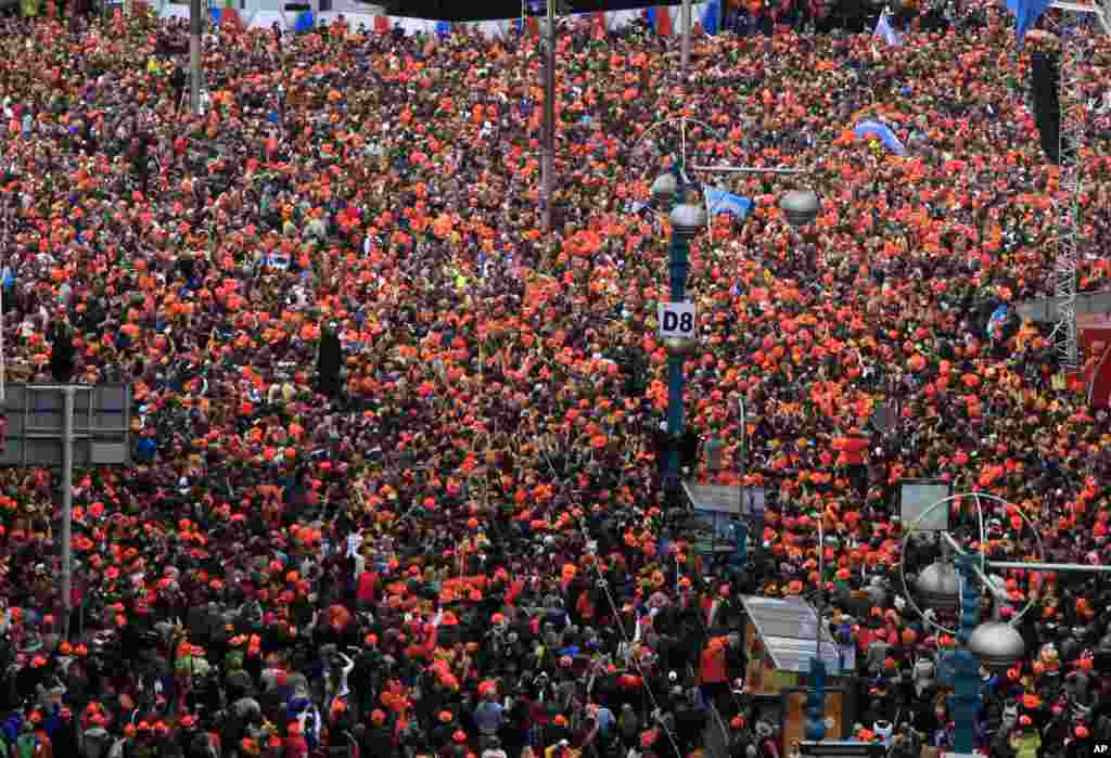 A crowd gathered in Dam Square to watch as King Willem-Alexander, Queen Maxima and Princess Beatrix sign the act of abdication in the Royal Palace in Amsterdam, the Netherlands. 
