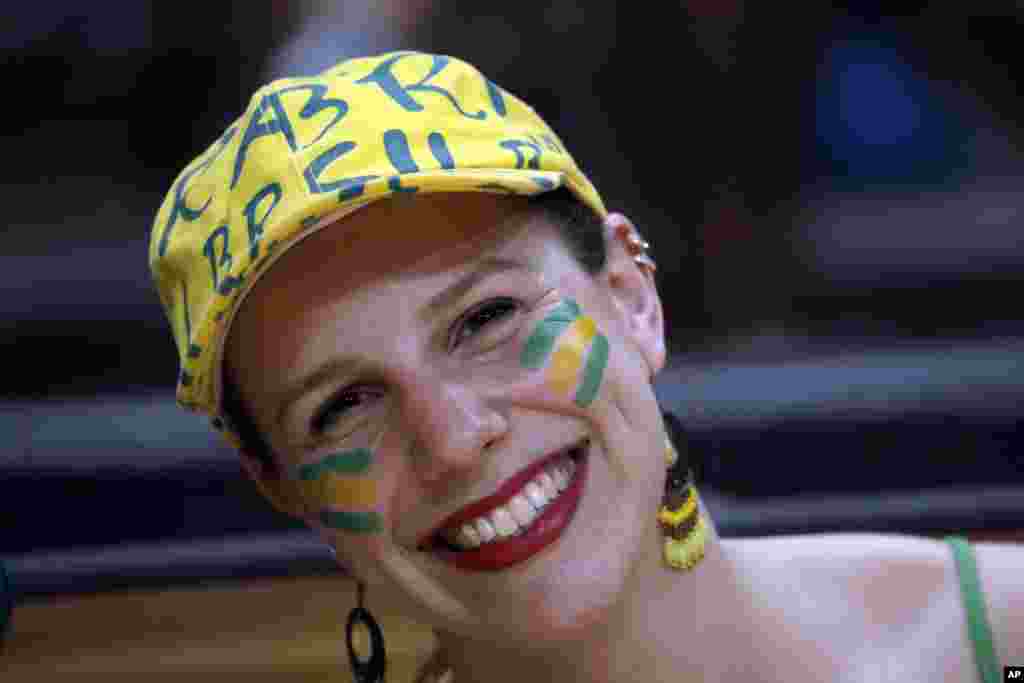 A fan sporting Brazil's colors is seen in the stands during a women's preliminary volleyball match between Brazil and Cameroon at the 2016 Summer Olympics in Rio de Janeiro, Brazil, Aug. 6, 2016.