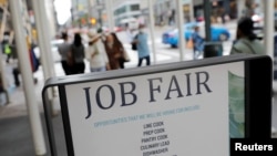FILE - Signage for a job fair is seen on Fifth Avenue in Manhattan, New York City, Sept. 3, 2021.