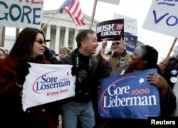 FILE - Supporters of Democrat U.S. Vice President Al Gore (R) and Republican Texas Governor George W. Bush face off against one another in front of the U. S. Supreme Court.