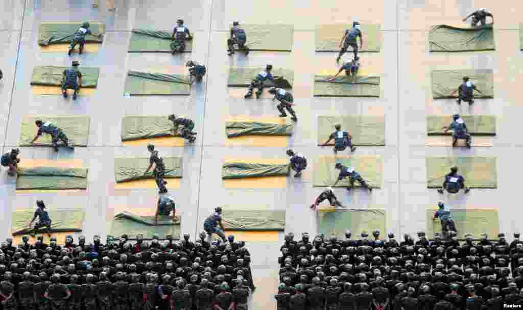 University students participate a competition of folding quilts during military training at the start of a new semester in Hengyang, Hunan Province, China.