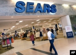 FILE - Shoppers walk into Sears in Peabody, Massachusetts, May 17, 2012.