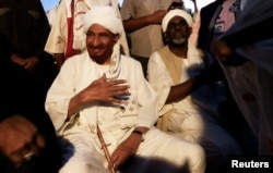 FILE - Sudanese leading opposition figure Sadiq al-Mahdi meets his supporters after he returned from nearly a year in self-imposed exile in Khartoum, Sudan, Dec. 19, 2018.