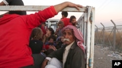 Displaced Iraqis from the Yazidi community arrive to the camp of Bajid Kandala at Feeshkhabour town near the Syria-Iraq border in Iraq, Aug. 9, 2014. 