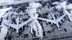 In this image taken from video provided by the Russian Defense Ministry Press Service, a pair of Tu-95 strategic bombers of the Russian air force are parked at an air base in Engels near the Volga River in Russia, Monday, Jan. 24, 2022. (Russian Defense M