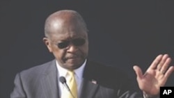 Republican presidential candidate Herman Cain announces he is suspending his campaign as his wife Gloria, left, looks on Saturday, Dec. 3, 2011, in Atlanta. "I am suspending my presidential campaign because of the continued distractions and the continued
