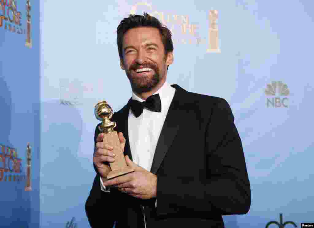 Actor Hugh Jackman holds up the award he won for Best Performance by an Actor in a Motion Picture Musical or Comedy for his performance in "Les Miserables," at the 70th annual Golden Globe Awards in Beverly Hills, California January 13, 2013.
