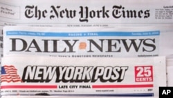 The premiere U.S. edition of The Times of London, bottom, is photographed with Tuesday editions of The New York Times, Daily News, and New York Post June 6, 2006 in New York. Rupert Murdoch's newspaper launched the U.S. edition as part of a push to make t