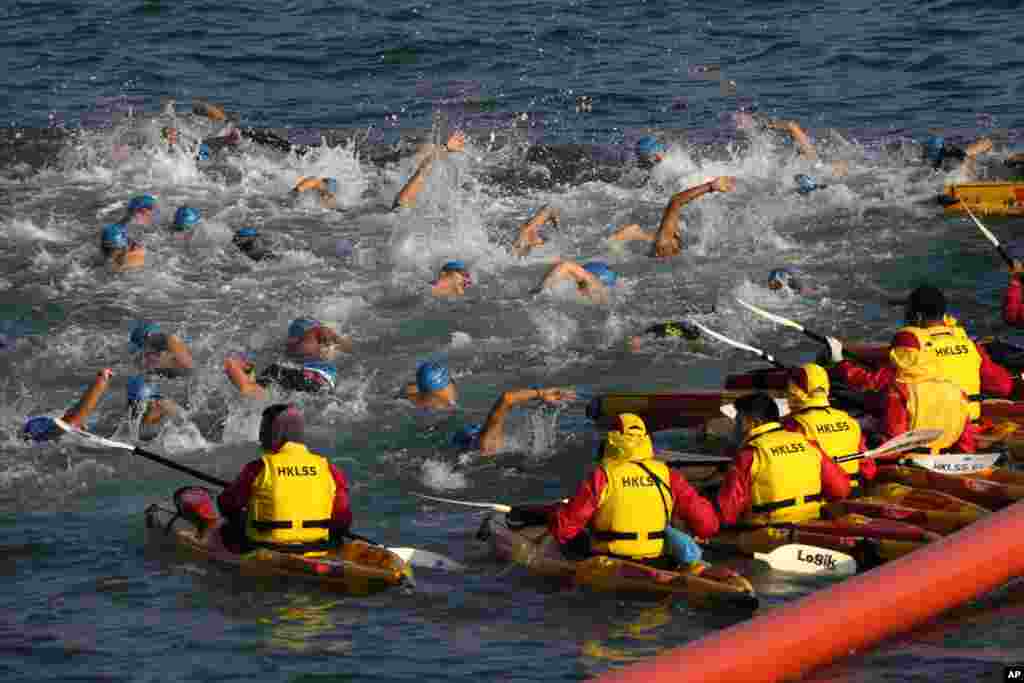 Competitors swim during a harbor race at the Victoria Harbor in Hong Kong.