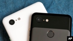 The cameras on the back of the Google Pixel 3 XL, left, and Google Pixel 3 smartphones are shown in this photo, in New York, Wednesday, Oct. 10, 2018. (AP Photo/Richard Drew)