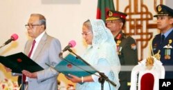 FILE - Bangladeshi President M. Abdul Hamid administers the oath of office to Prime Minister-elect Sheikh Hasina in Dhaka, Bangladesh, Jan. 7, 2019. The new government is Hasina's third in a row and fourth overall.