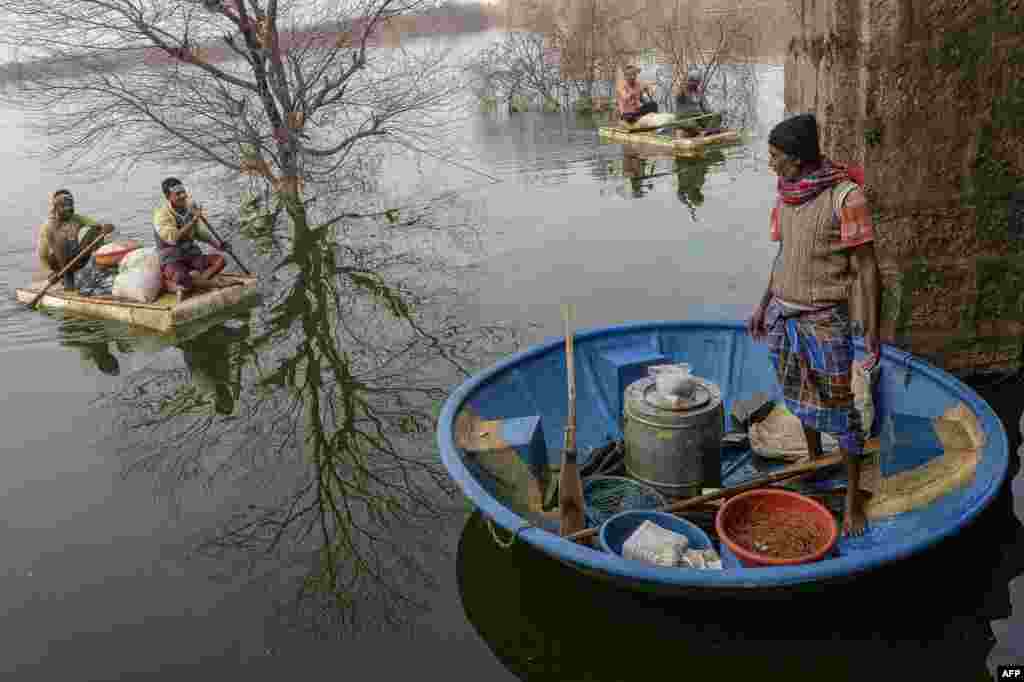 Fishermen return to the shore after catching fish at Turkayamjal lake on the outskirts of Hyderabad.