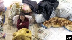 A victim of the March 11 earthquake and tsunami rests at a shelter in Kamaishi, Iwate Prefecture marking the one-month anniversary of the deadly quake which triggered the tsunami and nuclear crisis in Japan, April 11, 2011