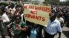 FILE - Zimbabwe's civil servants carry placards as they march during a protest in the streets of the capital Harare, Feb. 19, 2010. 