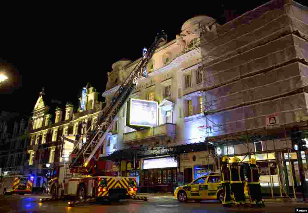 Emergency services look at the roof of the Apollo Theatre after part of the ceiling collapsed, Shaftesbury Avenue, London, Dec. 19, 2013.