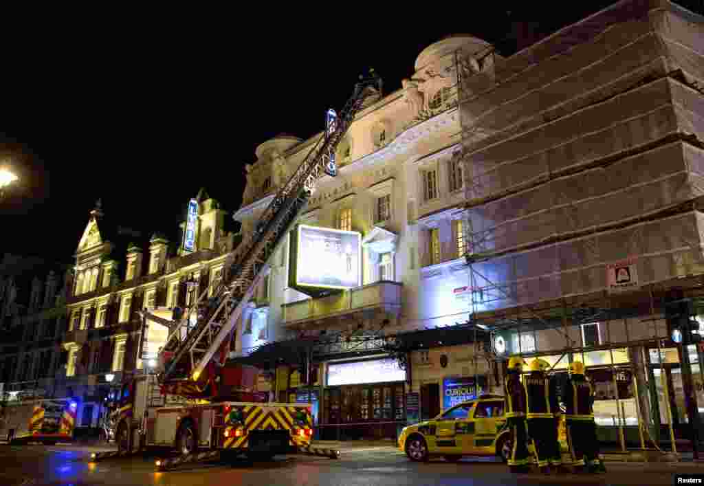 Emergency services look at the roof of the Apollo Theatre after part of the ceiling collapsed, Shaftesbury Avenue, London, Dec. 19, 2013. 