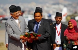 FILE - Maldives President Abdullah Yameen, center, is welcomed at Tribhuwan Airport to attend the South Asian Association for Regional Cooperation summit in Katmandu, Nepal, Nov. 25, 2014.
