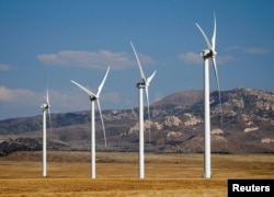 FILE - Wind turbines operate at a wind farm near Milford, Utah, May 21, 2012.
